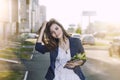 Beautiful woman walks around the city listening to music in head