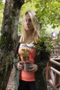 Beautiful woman wanders in the autumn forest and drinks coffee