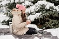 Beautiful woman in warm winter clothes holding cup drinking hot tea or coffee outdoors in snowy day Royalty Free Stock Photo