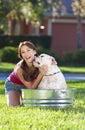 Beautiful Woman Washing Her pet Dog In A Tub Royalty Free Stock Photo