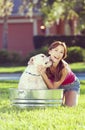 Beautiful Woman Washing Her pet Dog In A Tub Royalty Free Stock Photo