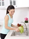 Beautiful woman Washing vegetables Royalty Free Stock Photo