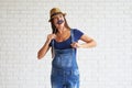 Beautiful woman wear denim overalls and holding mustache mask Royalty Free Stock Photo