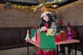 Woman wear santa claus hat showing green gift bag on hand in restaurant. concept of Christmas party and New year party Royalty Free Stock Photo