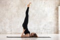 Beautiful woman practicing yoga, Salamba Sarvangasana pose, Shoulder stand