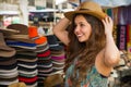 Beautiful woman wearing a handmade Panama Hat at the craft market in Otavalo, Ecuador, colorful fabrics background