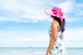 Beautiful woman wearing hat beach and sunglasses stand on hands over sandy beach Royalty Free Stock Photo