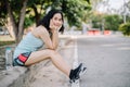 A beautiful woman wearing a jogging suit in the park early in the morning along with a clean drinking water bottle concept of Royalty Free Stock Photo