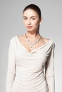 Beautiful woman wearing marble necklace on grey background Royalty Free Stock Photo