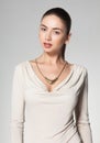 Beautiful woman wearing necklace on grey background Royalty Free Stock Photo