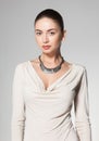 Beautiful woman wearing necklace on grey background Royalty Free Stock Photo