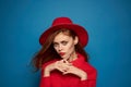 beautiful woman wearing a red hat cosmetics posing blue background Royalty Free Stock Photo