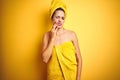 Beautiful woman wearing shower towel on body and head over yellow isolated background touching mouth with hand with painful Royalty Free Stock Photo