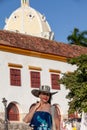 Beautiful woman wearing the traditional Colombian hat called Sombrero Vueltiao at the historical Calle de la Ronda of the Royalty Free Stock Photo