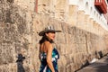 Beautiful woman wearing the traditional Colombian hat called Sombrero Vueltiao at the historical Calle de la Ronda of the Royalty Free Stock Photo