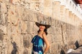 Beautiful woman wearing the traditional Colombian hat called Sombrero Vueltiao at the historical Calle de la Ronda of the Royalty Free Stock Photo