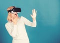 Beautiful woman wearing virtual reality goggles in studio. Confident young woman adjusting her virtual reality headset