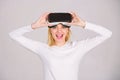 Beautiful woman wearing virtual reality goggles in studio. Excited smiling businesswoman wearing virtual reality glasses