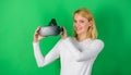 Beautiful woman wearing virtual reality goggles in studio. Person with virtual reality helmet isolated on green Royalty Free Stock Photo