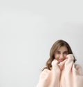 Beautiful woman wearing warm pink sweater on light background. Space for text