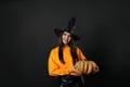 Beautiful woman wearing witch costume with pumpkin for Halloween party Royalty Free Stock Photo