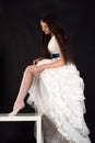 Beautiful woman in a wedding dress straightens stockings Royalty Free Stock Photo