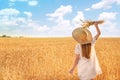 Beautiful woman with wheat spikelets in field on sunny day Royalty Free Stock Photo