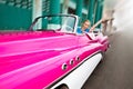 The beautiful woman at a wheel old American retro car in Old Havana, Cuba Royalty Free Stock Photo