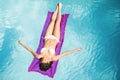 Beautiful woman in white bikini relaxing on air bed in pool Royalty Free Stock Photo