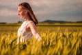 Beautiful woman in white dress on golden yellow wheat field Royalty Free Stock Photo