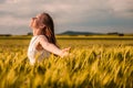 Beautiful woman in white dress on golden yellow wheat field Royalty Free Stock Photo