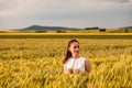 Beautiful woman in white dress on golden yellow wheat field Royalty Free Stock Photo