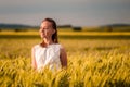 Beautiful woman in white dress on golden yellow wheat field Royalty Free Stock Photo