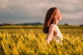 Beautiful woman in white dress on golden yellow wheat field Royalty Free Stock Photo