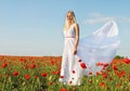 Beautiful woman in white dress on poppy field Royalty Free Stock Photo