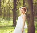 Beautiful woman in white dress posing in forest Royalty Free Stock Photo