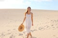 Beautiful woman with white dress walking on dunes in desert, Corralejo, Fuerteventura Royalty Free Stock Photo