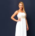 Beautiful woman in a white gala dress and looking gorgeous for prom, orcars or red carpet event. Portrait a fashion and Royalty Free Stock Photo