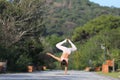 A beautiful woman in a white gymnastic jumpsuit is engaged in yoga. Royalty Free Stock Photo