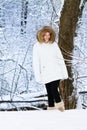Beautiful woman in white jacket in a snowy park