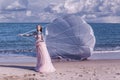 Beautiful woman with white parachute at the beach background portrait beauty portrait photoshoot Royalty Free Stock Photo