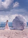 Beautiful woman with white parachute at the beach background portrait beauty portrait photoshoot Royalty Free Stock Photo