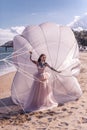 Beautiful woman with white parachute at the beach background portrait beauty portrait photoshoot Royalty Free Stock Photo