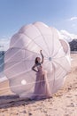 Beautiful woman with white parachute at the beach background portrait beauty portrait photoshoot Royalty Free Stock Photo