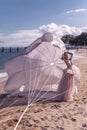 Beautiful woman with white parachute at the beach background portrait beauty portrait photoshoot Royalty Free Stock Photo