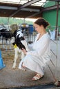 Beautiful woman in white robe caresses small cute Royalty Free Stock Photo