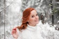 Beautiful woman in white sweater in snowy forest Royalty Free Stock Photo
