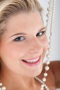 Beautiful woman with white teeth and pearls Royalty Free Stock Photo