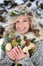 Beautiful woman with white teeth and perfect smile. Happy sincere winter outdoor portrait of attractive model with flowers Royalty Free Stock Photo