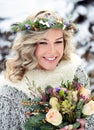 A beautiful woman with white teeth and a perfect smile. Happy sincere winter outdoor portrait of a attractive model with flowers Royalty Free Stock Photo